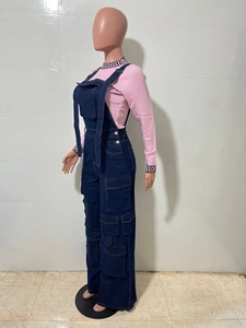 Detail of pink knit top with Greek key pattern and navy cargo denim overalls on mannequin