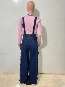 Rear view of wide-leg denim overalls with cargo pockets and pink knitted sweater