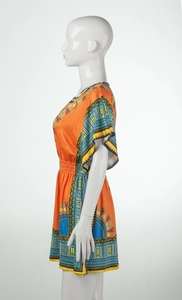 Detail of Dashiki style geometric patterns on an orange ethnic elastic waist dress