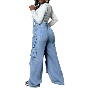 Detail of light blue denim cargo overalls with wide leg cut and side flap pockets
