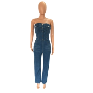 Detail of blue denim tube jumpsuit with metal buttons, waist tie, and frayed hem edges