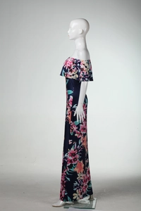 Detail of off-shoulder ruffled neckline with tropical floral print on navy blue dress