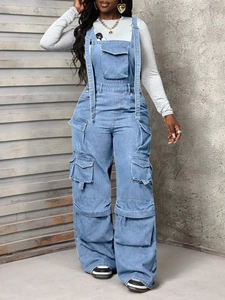 Detail of light blue denim overalls showing cargo pockets and adjustable strap buckles