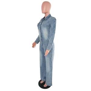 Detailed side view of washed blue denim jumpsuit with lapel collar and metal buttons
