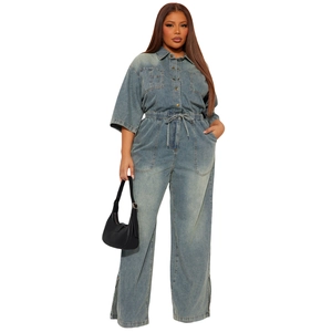 Detail of blue wash denim jumpsuit showing elastic drawstring waist and side slit leg