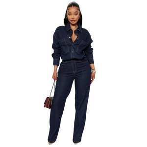 Detailed close-up of dark blue denim jumpsuit with contrasting yellow stitching and chest pockets