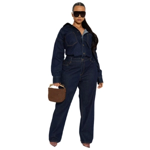 Detail of dark blue denim jumpsuit featuring chest pockets and contrast yellow stitching