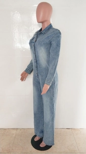 Side view of light blue washed denim jumpsuit featuring metal buttons and flared leg cut