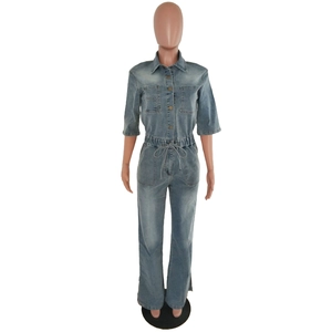Detail of light blue washed denim jumpsuit featuring front pockets and drawstring waist