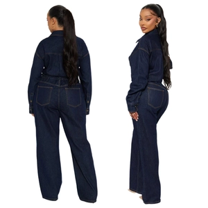 Detail of dark blue denim jumpsuit featuring contrast stitching and elastic waist