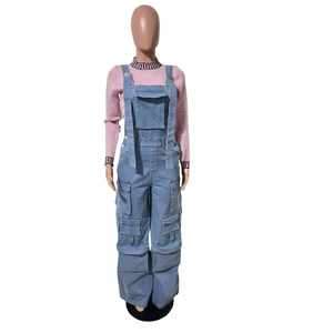 Detail of light blue denim overalls with cargo pockets and pink long sleeve base layer