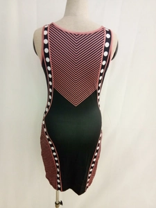 Detail view of pink geometric V-pattern and white polka dot side panels on a bodycon dress