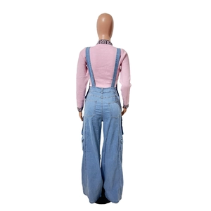 Rear view of light blue denim wide-leg overalls with pink knit top and back pocket detail