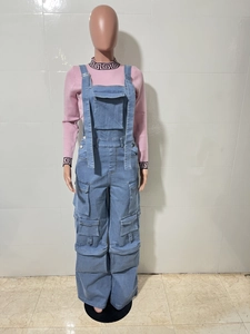 Detailed view of light wash denim overalls with cargo pockets and pink knit sweater