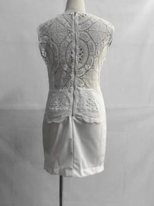Detail of white sleeveless dress with intricate crochet embroidery and back zipper closure