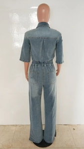 Rear view detail of denim jumpsuit showing elastic waist and back patch pockets