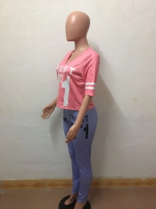 Detail of pink V-neck T-shirt and purple leggings with white TRUST NO 1 letter printing
