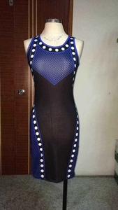 Detail of slim fit sleeveless dress featuring blue geometric lines and white polka dots