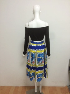 Women's two-piece set featuring off-shoulder black long sleeve top and printed maxi skirt