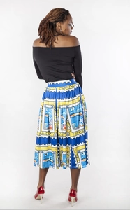 Back view of women's long sleeve off-shoulder top and colorful stamp print pleated skirt