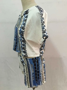 Side view of two-piece set featuring ethnic geometric print on beige short set