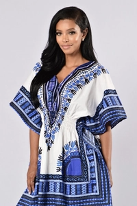 Close-up of V-neck and ethnic blue pattern on a white dashiki style dress