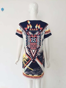 Detail view of ethnic geometric print and palm tree landscape on a short sleeve dress