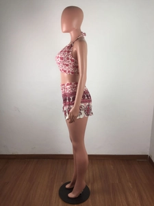 Side view of red and white ethnic print summer set with halter crop top and high waist shorts