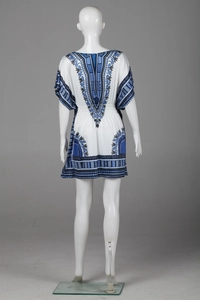 Detail view of ethnic totem prints and elastic waist on the white bohemian mini dress