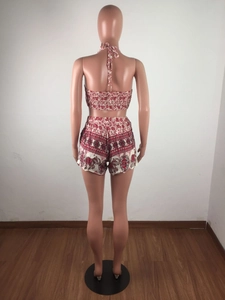 Detail view of the back of a red elephant print halter crop top and shorts set
