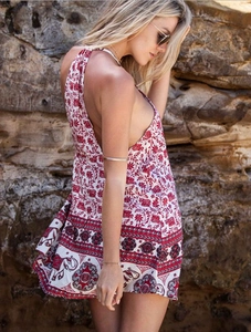 Detail of red and white boho mini dress showing elephant print and floral patterns