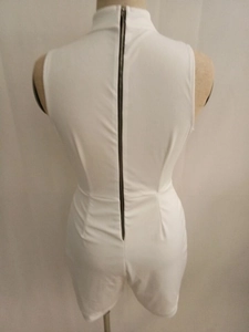Detail view of white sleeveless bodysuit featuring a sleek long back metal zipper