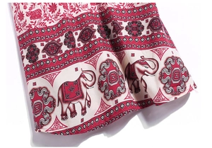 Close-up detail of ethnic elephant print and floral patterns on summer dress hemline