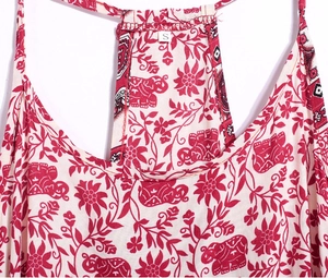 Detail of red elephant print dress with thin straps and size S label on neckline