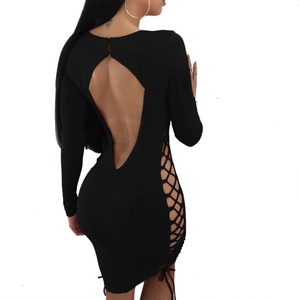 Detail showing the backless design and crisscross lace-up side of the black mini dress