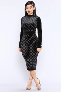 Detail of black velvet bodycon dress featuring intricate silver rhinestone rhombus pattern