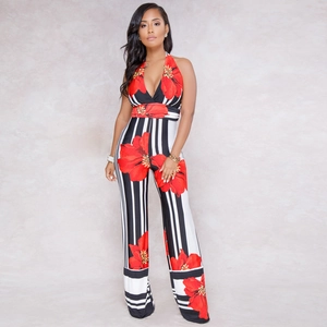 Detail of sexy halter V-neck jumpsuit with striped pattern and bold red floral prints