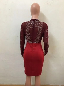Detailed back view of burgundy long sleeve dress with sheer mesh and rhinestone patterns