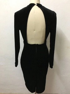Detail of black velvet bodycon dress featuring an open back design and metal zipper