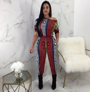 Chic women's two-piece set featuring off-shoulder top and wide-leg pants with geometric print
