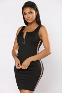 Detail view of the metal zipper closure and side stripe design on a black mini dress
