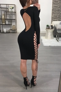 Detailed close-up of a black lace-up open back cocktail dress with side cutout details
