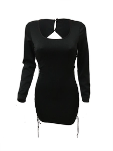 Detailed view of black lace open back dress with drawstring sides and button closure