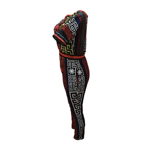 Detail of multi-color jumpsuit featuring Greca patterns and vibrant geometric prints