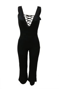 Detailed close-up of a black lace-up jumpsuit featuring a deep V-neck and metal eyelets