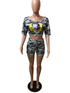 Close-up of camouflage tracksuit with digital portrait print and beaded details
