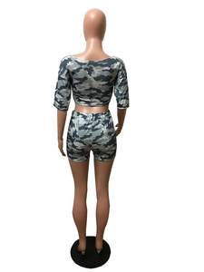 Back view of women's camo print two-piece set featuring cropped top and slim shorts