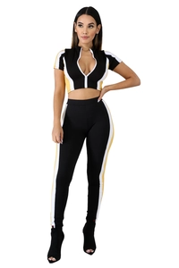 Women's black 2-piece tracksuit set with yellow and white stripes on sleeves and pants