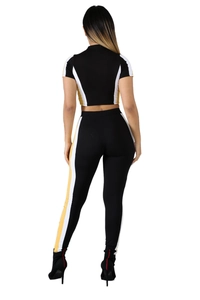 Women's 2-piece sportswear set with black, yellow, and white patchwork and crop top