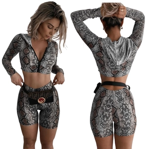 Detail showing the faux snakeskin print texture on the hooded top and matching shorts